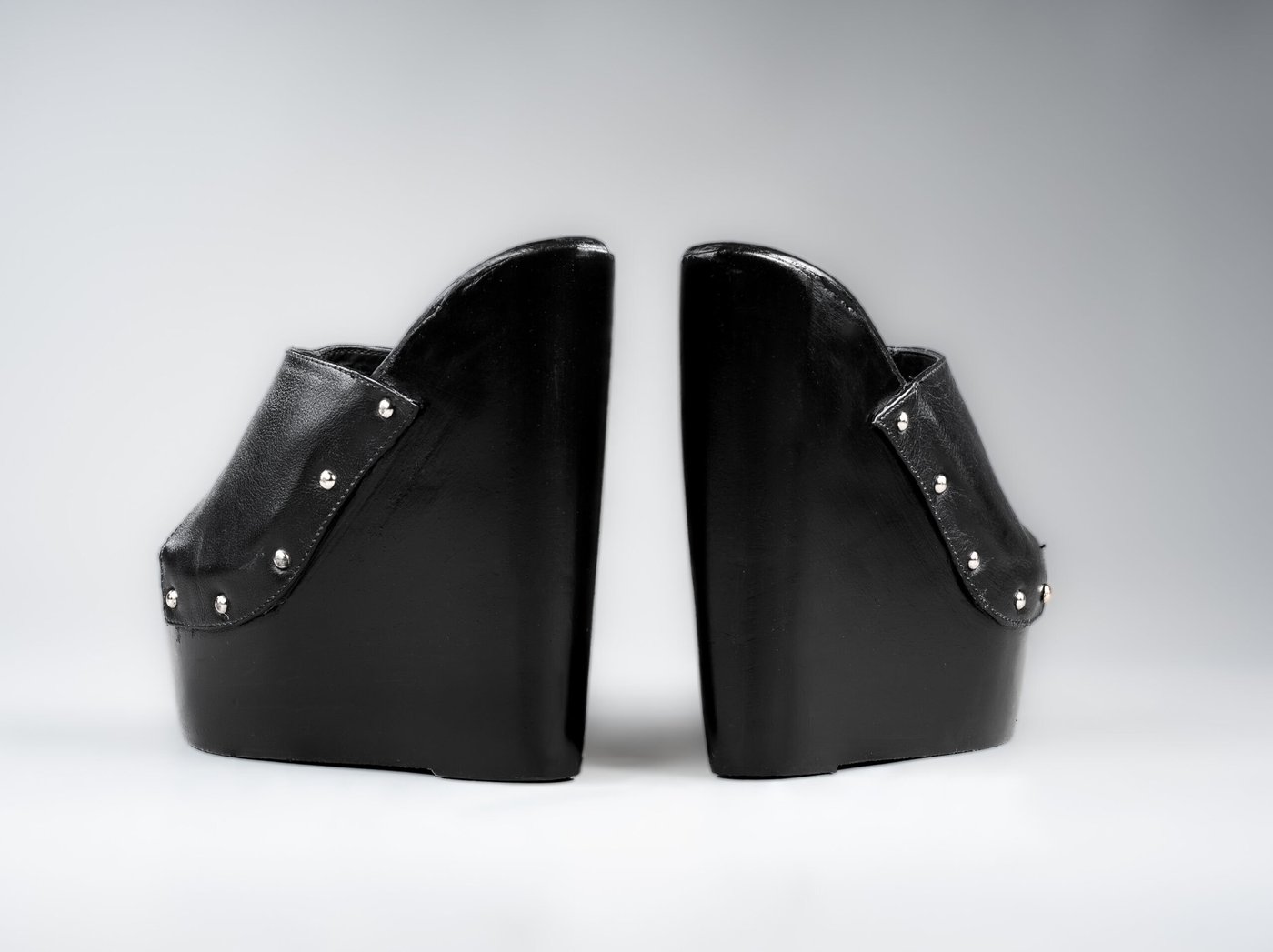 Amber wedge mule, backless slide silhouette and solid wood wedge profile